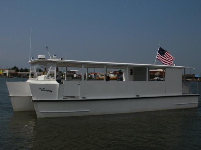 Custom Evans passenger ferry with American flag at dock