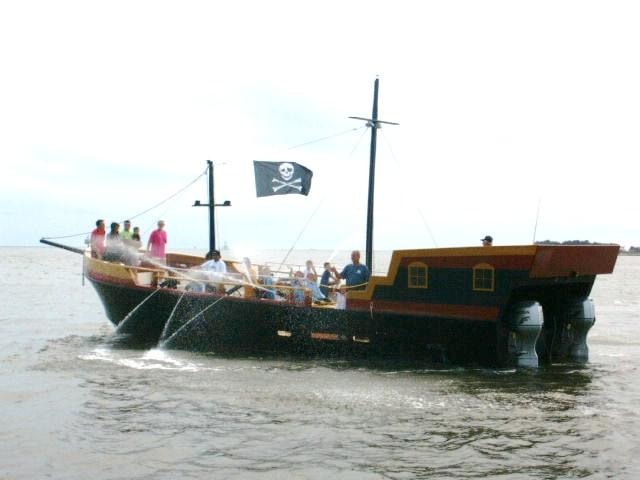 Custom Evans pirate ship with Jolly Roger flag and passengers