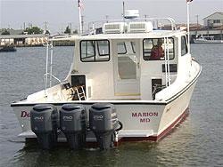 Marion MD — custom Evans boat with triple outboards at dock