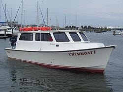 Crewboat I — custom Evans crew boat at marina
