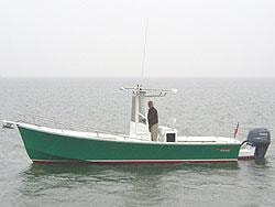 Green center console fishing boat on calm water