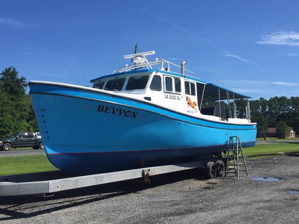 Bevvon — large blue and white workboat on trailer at Evans Boat Repair