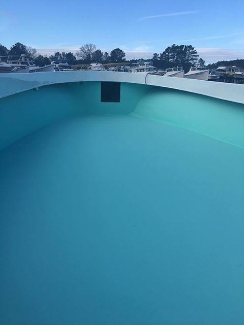 Freshly fiberglassed boat deck interior painted turquoise at Evans Boat Repair