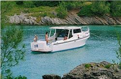 White custom Evans cabin boat in turquoise water