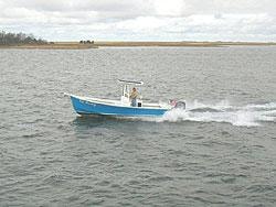 Blue center console running through open water